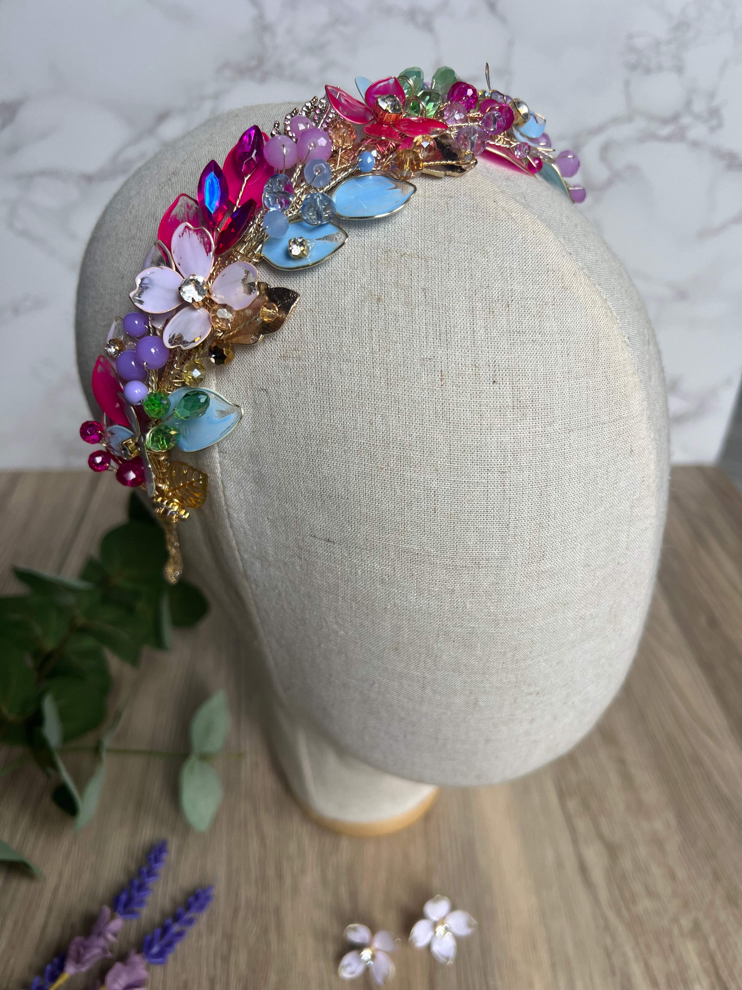 Lilac, blue and Fucshia detail low style headpiece Lilac, blue and Fucshia detail low style headpiece Precius pearls